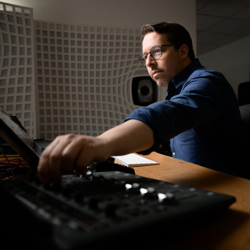 Eric Horstmann mixing at his Immersive Lab studio with his hand on a controller