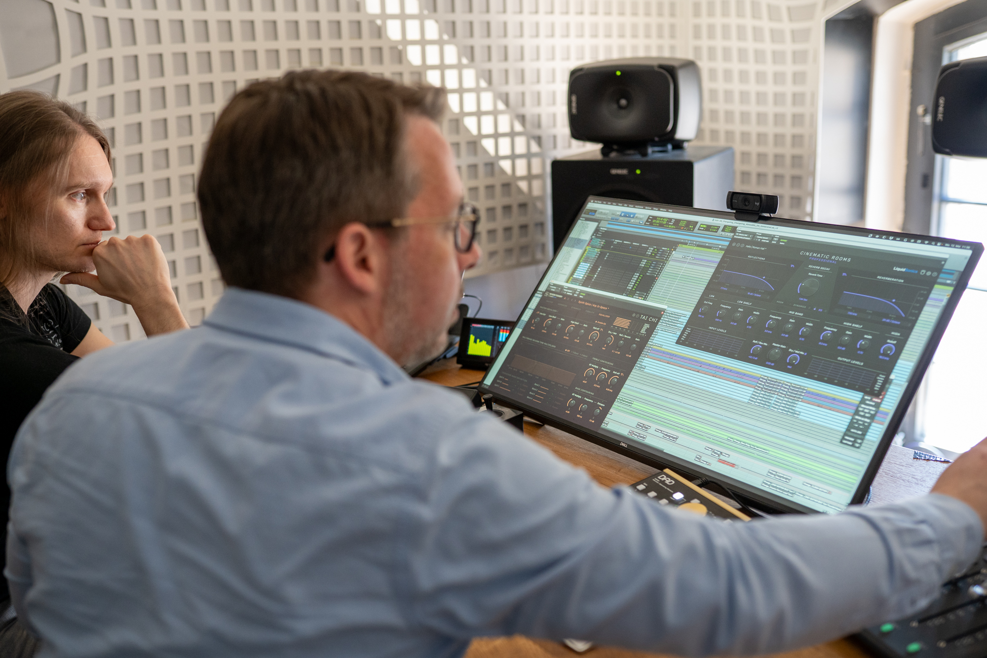 Tom Fountainhead and Eric Horstmann looking at a screen with Liquidsonics plugins Cinematic Rooms and Tai Chi
