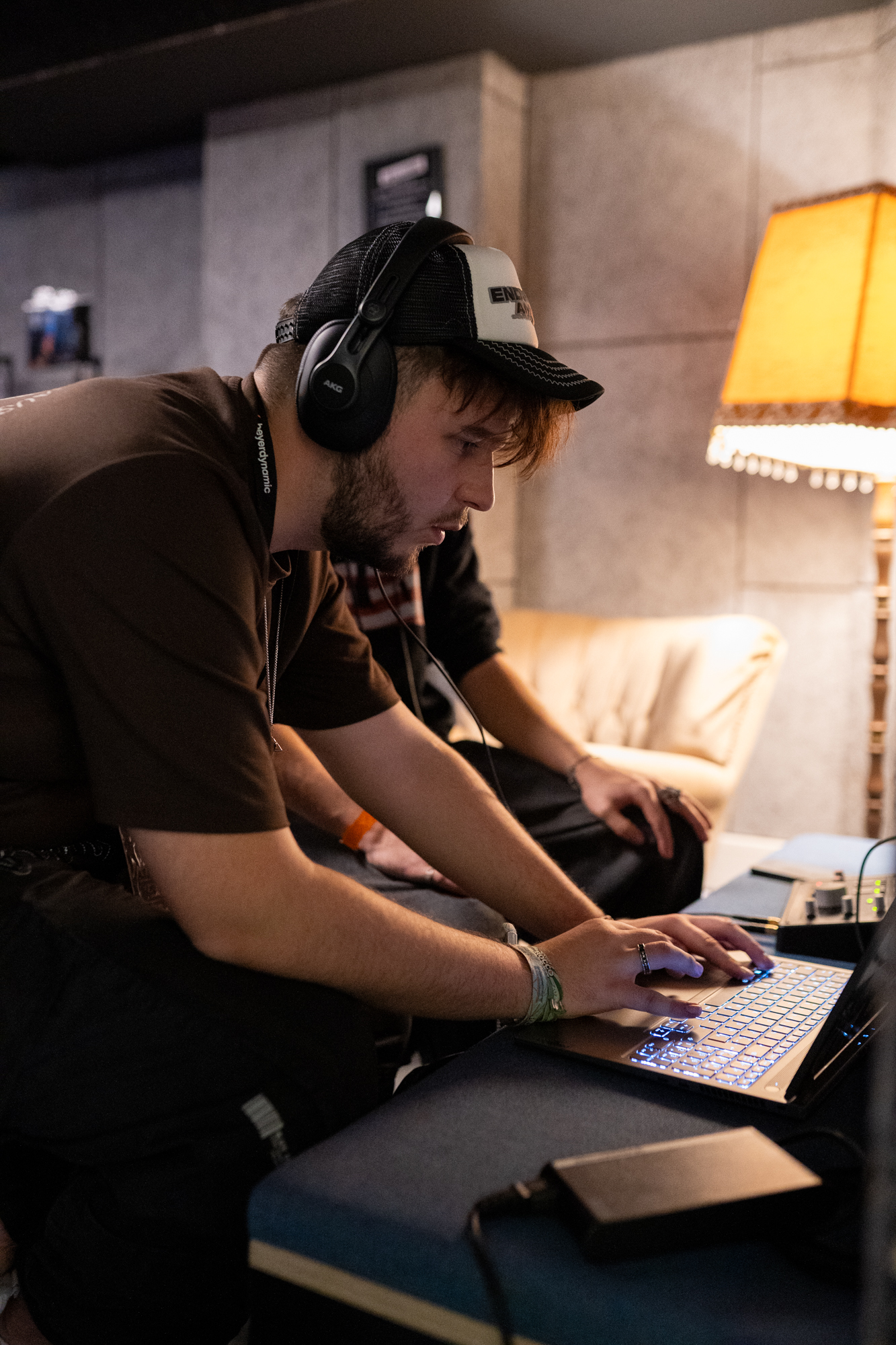 A man with headphones working on a laptop at Beatcon 2025 in Berlin.