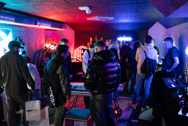 A packed demo room with neon lights at Beatcon Berlin, 2025