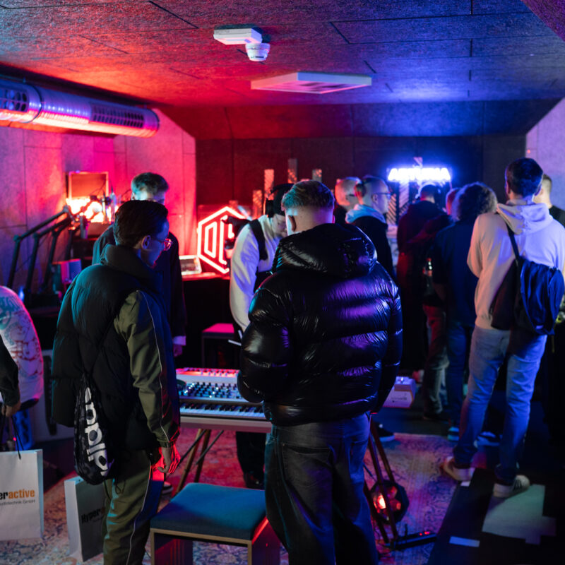 A packed demo room with neon lights at Beatcon Berlin, 2025