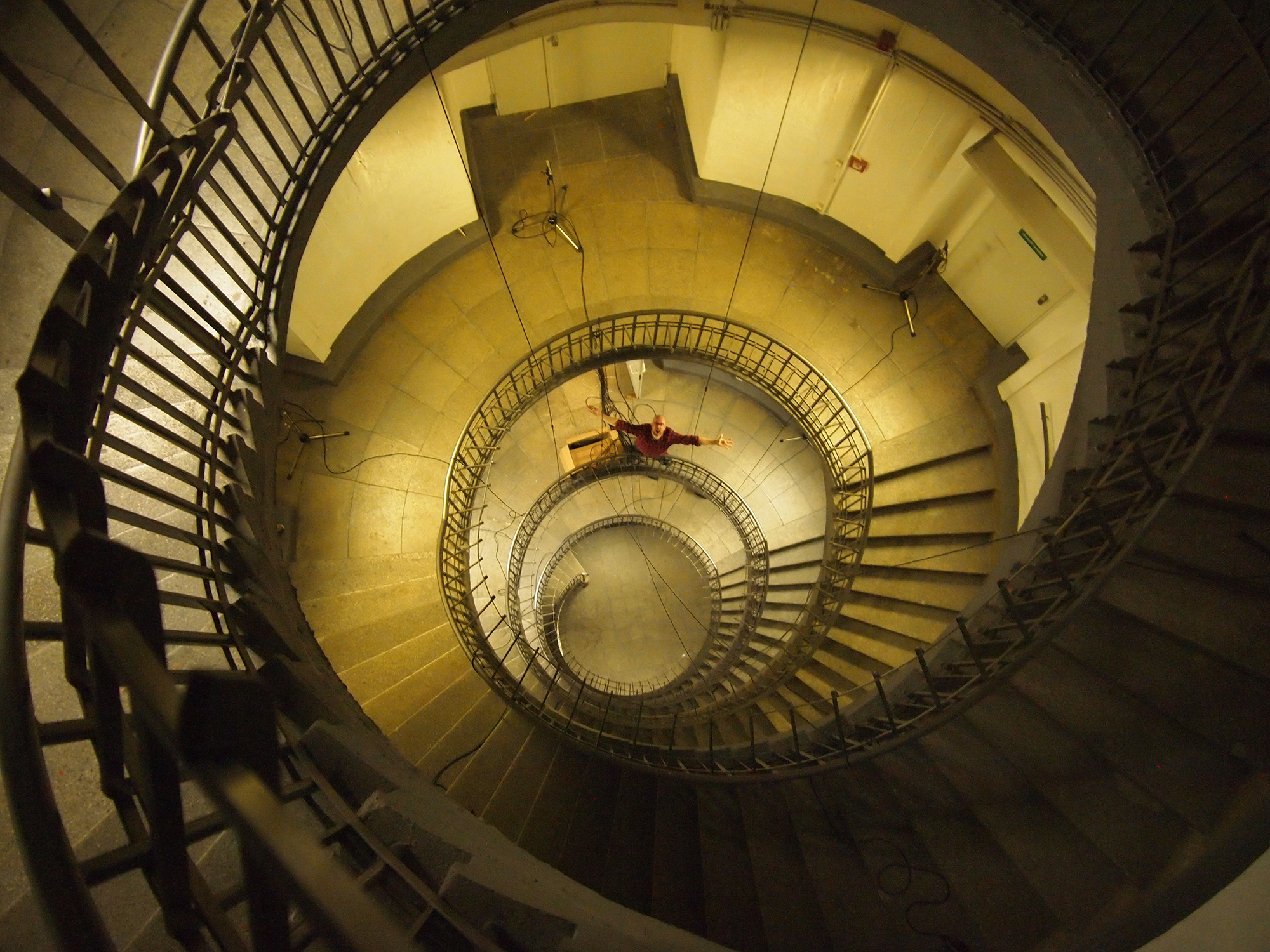 Grammy-winning engineer Hans-Martin Buff standing at the bottom of the spiral staircase of the Heiligengeistfeld Bunker in Hamburg, Germany.