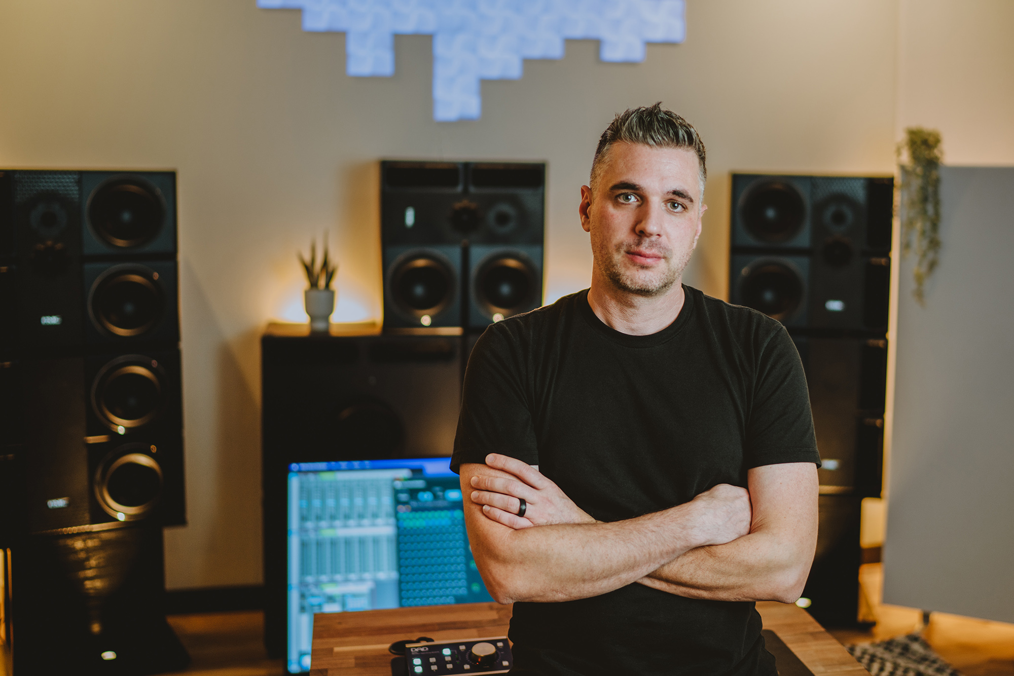 Mixing engineer Sam Polizzi in front of PMC speakers at his Dolby Atmos studio.