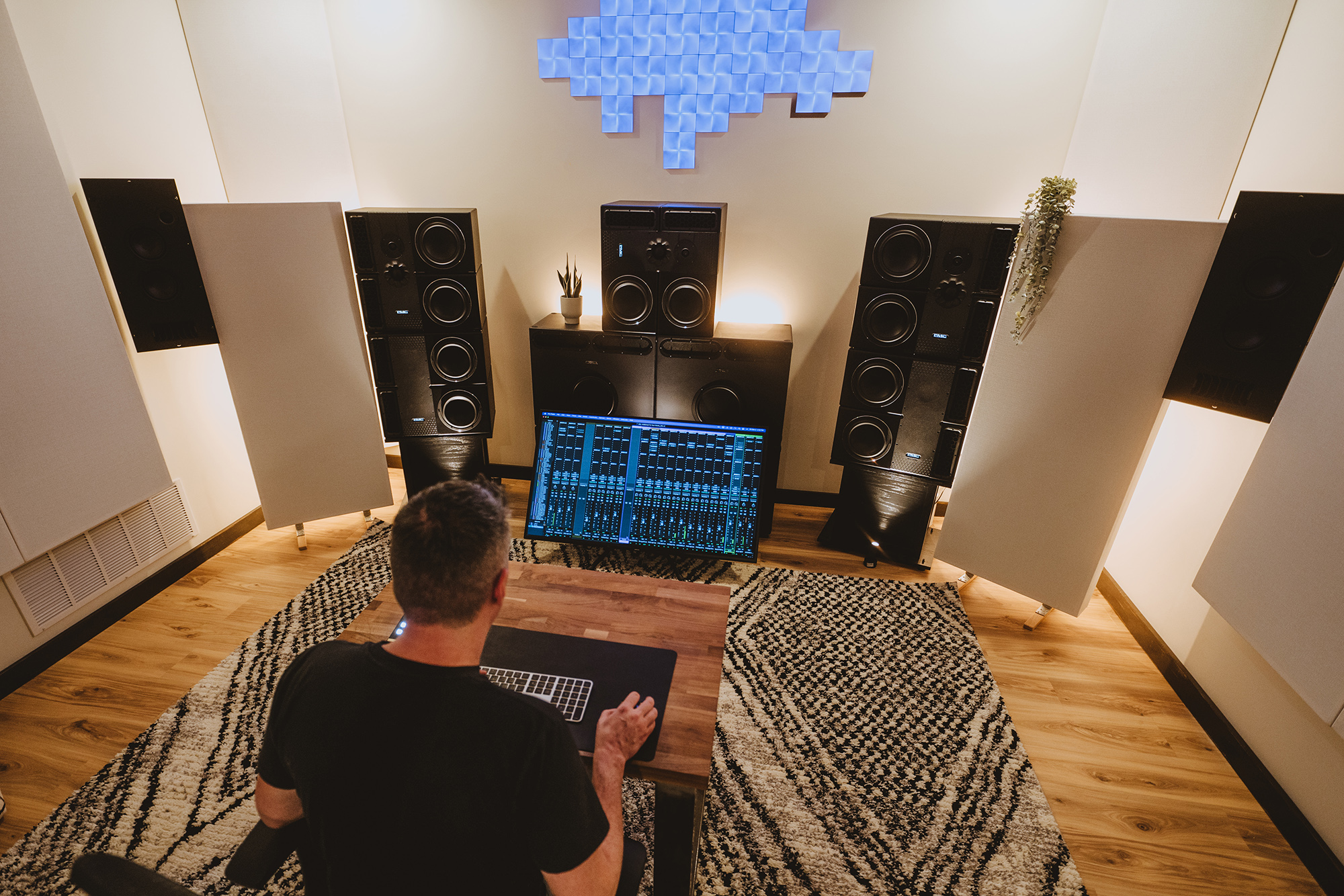 Over the shoulder view of Sam Polizzi at his Dolby Atmos mixing studio.